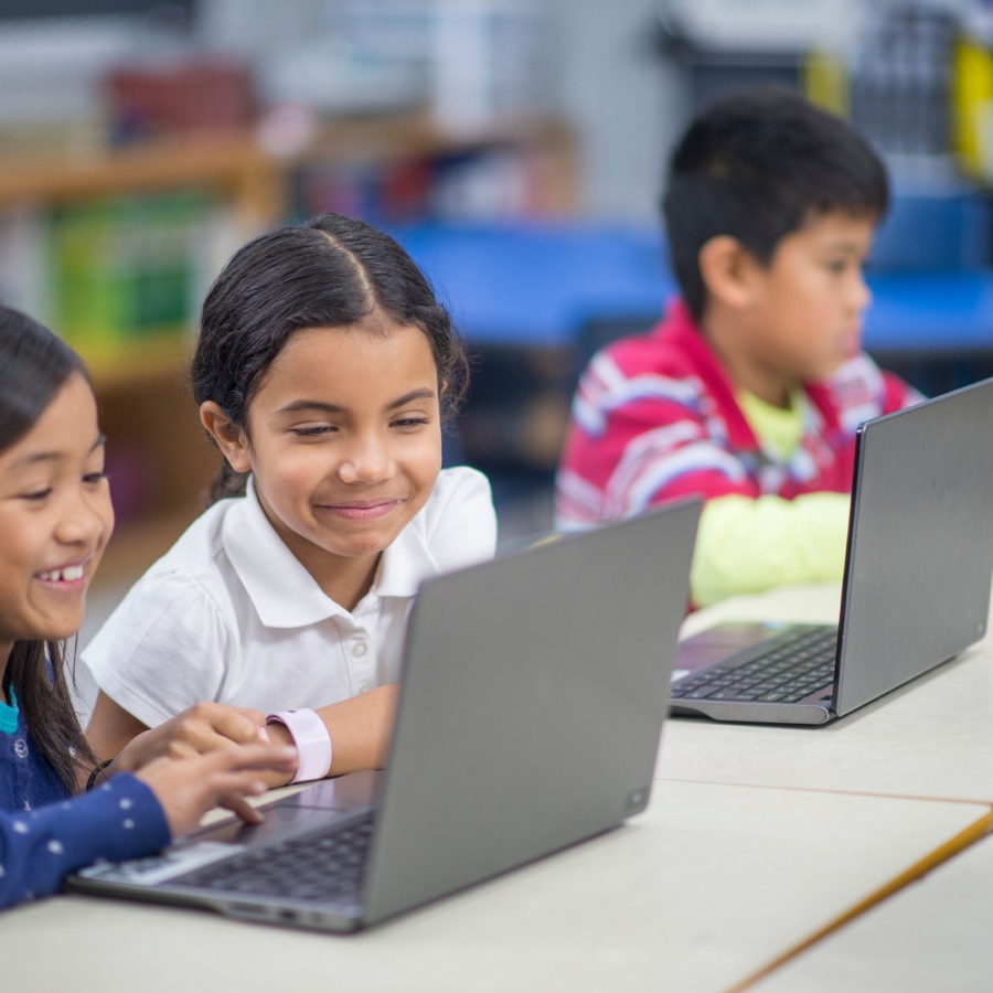 Kids working on laptops in a classroom