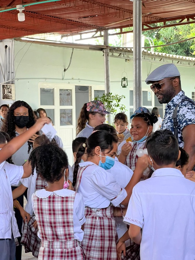 Kids-Teck founder greeting a group of uniformed students